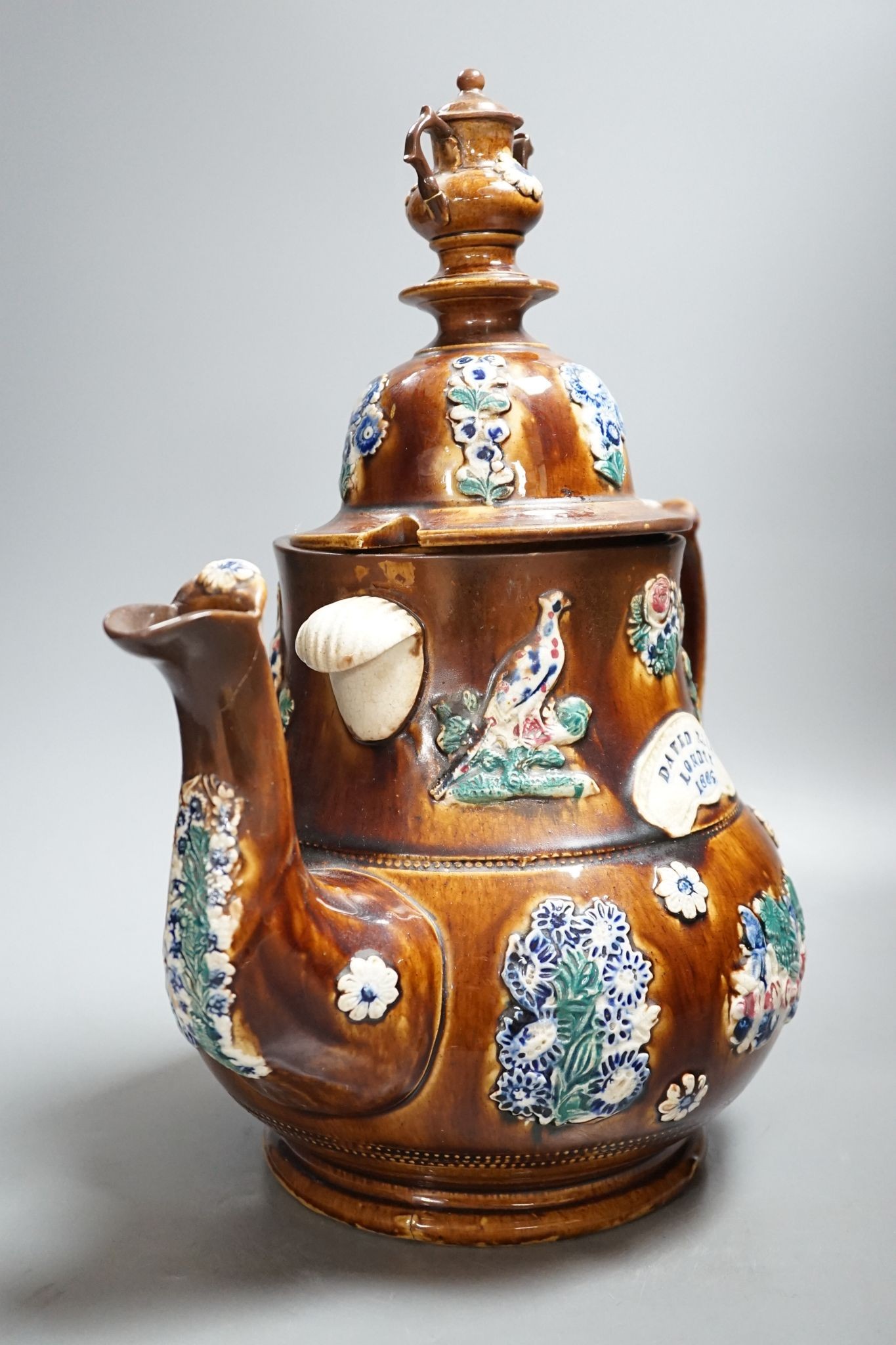 A large Measham bargeware teapot, 1886 (restored) 40cm